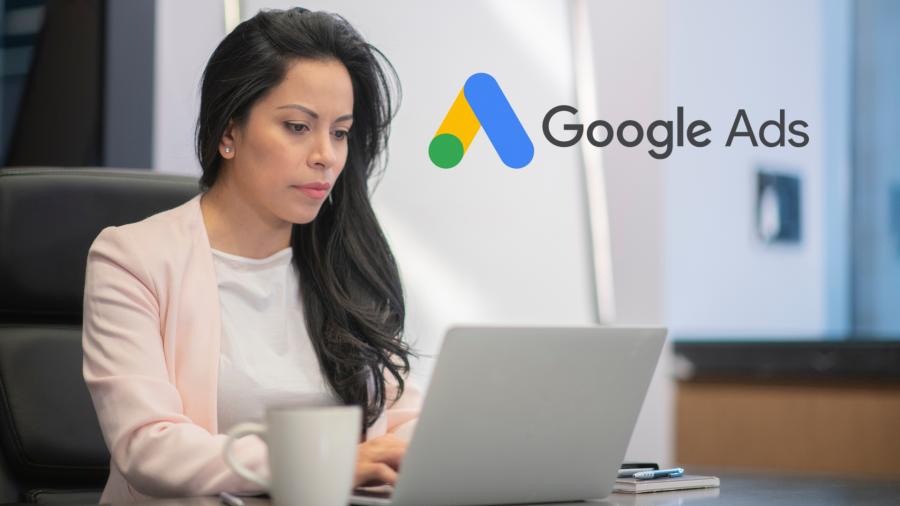 Woman working on laptop at a desk with Google Ads logo at top right corner of image