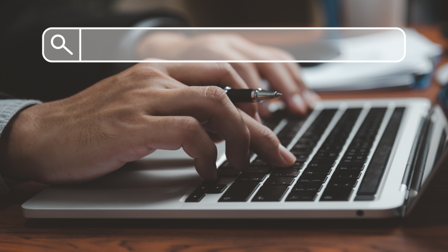 Person typing on laptop keyboard